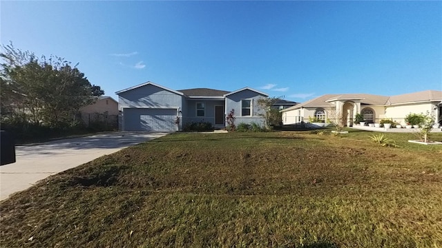 ranch-style home featuring a garage and a front lawn