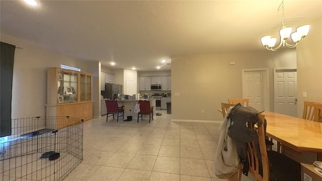 dining room featuring a chandelier and light tile patterned floors