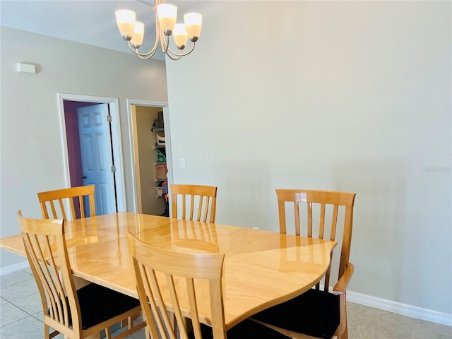 dining room with a chandelier and light tile patterned floors