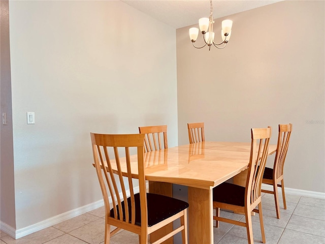 tiled dining space featuring an inviting chandelier