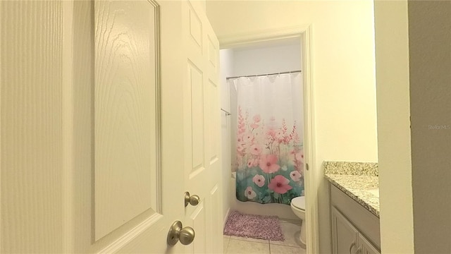 bathroom with tile patterned flooring, vanity, toilet, and walk in shower