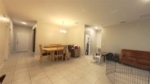 dining area featuring light tile patterned floors and an inviting chandelier