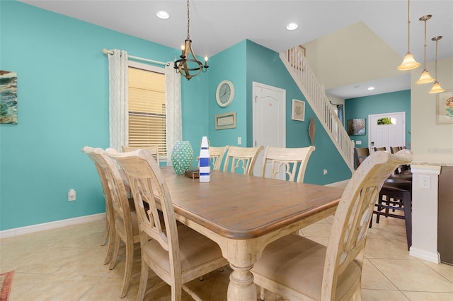 tiled dining room with a chandelier