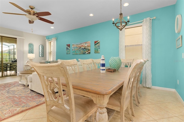 dining room with light tile patterned flooring and ceiling fan with notable chandelier