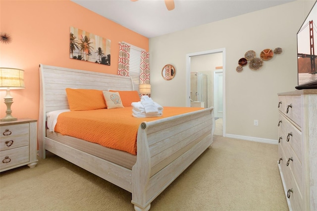 carpeted bedroom featuring ceiling fan and ensuite bathroom