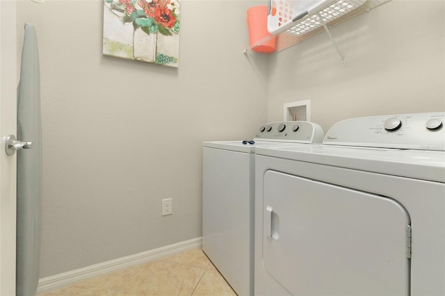 laundry area featuring light tile patterned floors and independent washer and dryer