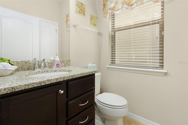 bathroom with vanity, tile patterned floors, and toilet