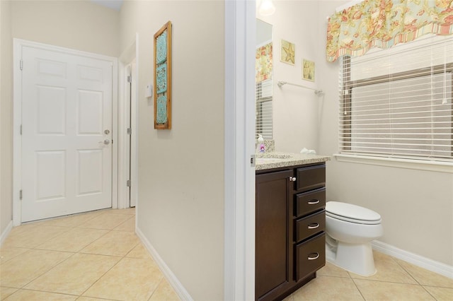 bathroom featuring toilet, vanity, and tile patterned floors