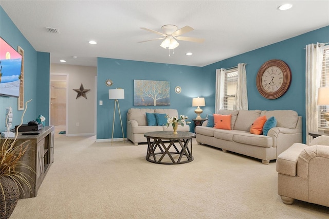 living room featuring light colored carpet and ceiling fan