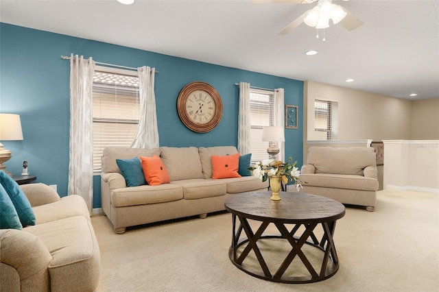 carpeted living room featuring ceiling fan