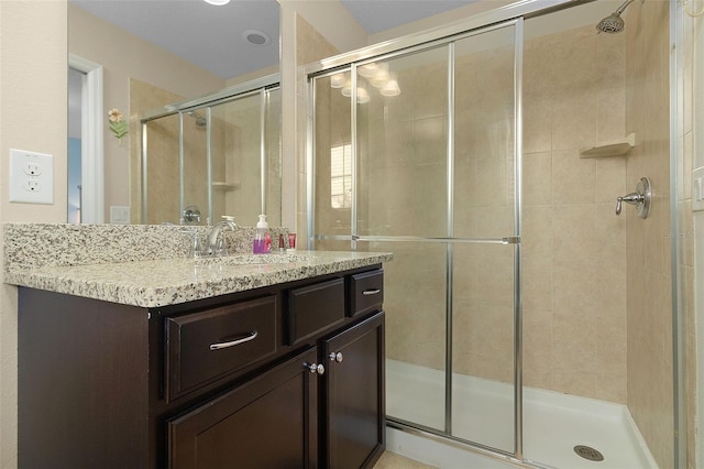 bathroom with vanity and a shower with shower door