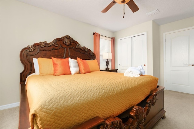 carpeted bedroom featuring ceiling fan and a closet