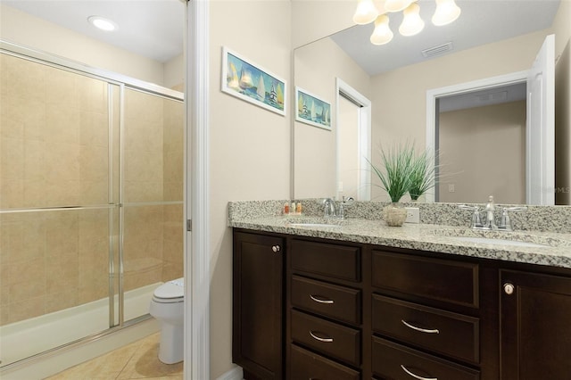 bathroom featuring toilet, vanity, tile patterned floors, and walk in shower