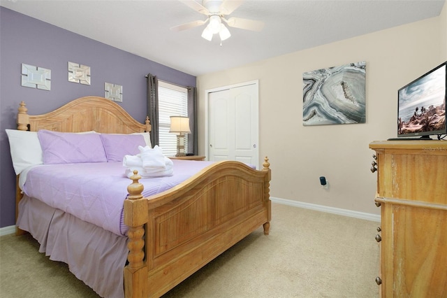 carpeted bedroom with a closet and ceiling fan