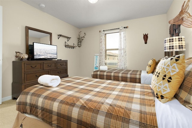 bedroom featuring light colored carpet