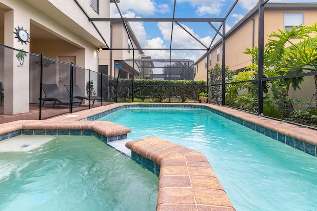 view of swimming pool with glass enclosure and a patio