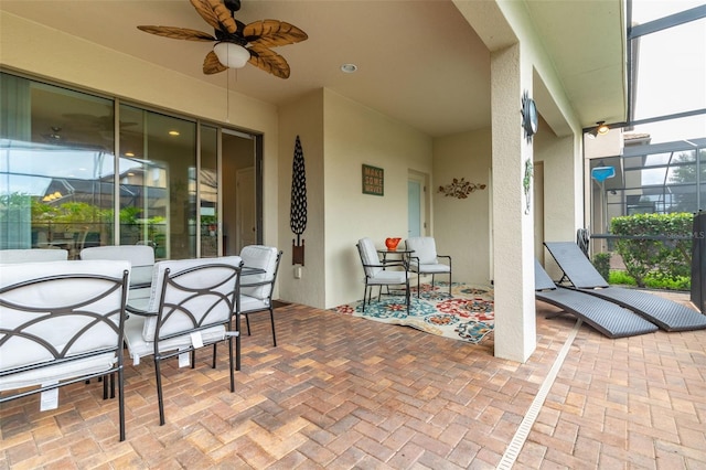 view of patio featuring a lanai and ceiling fan