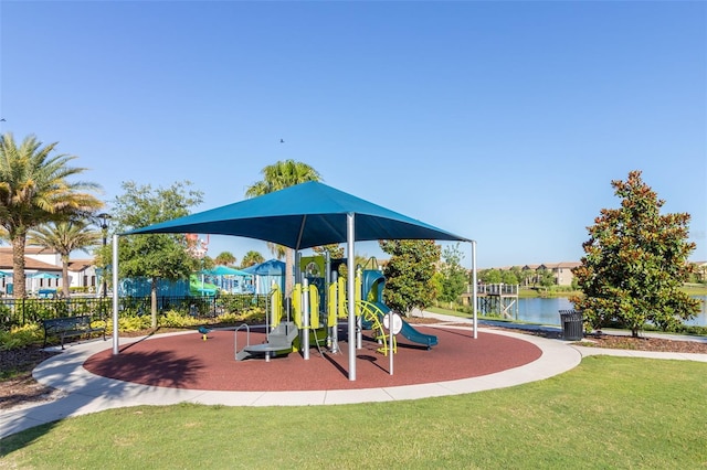 view of playground with a water view and a yard