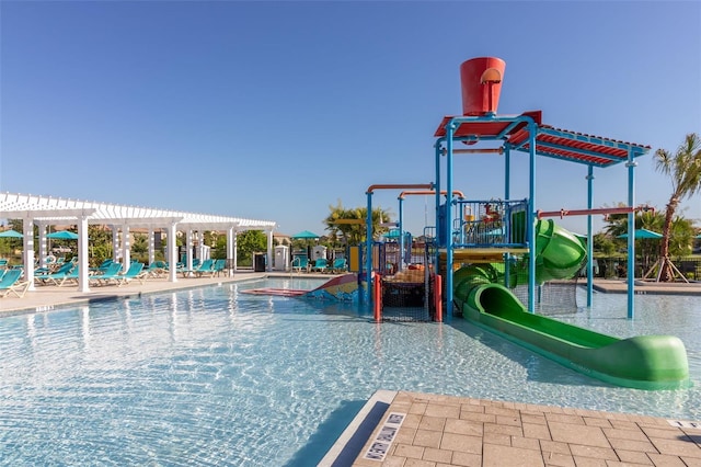 view of play area featuring a jacuzzi and a pergola