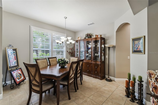 dining room featuring an inviting chandelier and light tile patterned floors