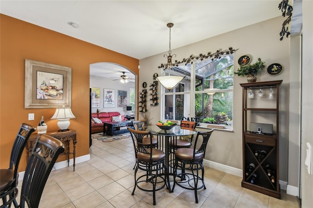 tiled dining space with ceiling fan