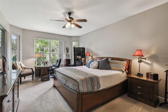 bedroom with ceiling fan and light colored carpet