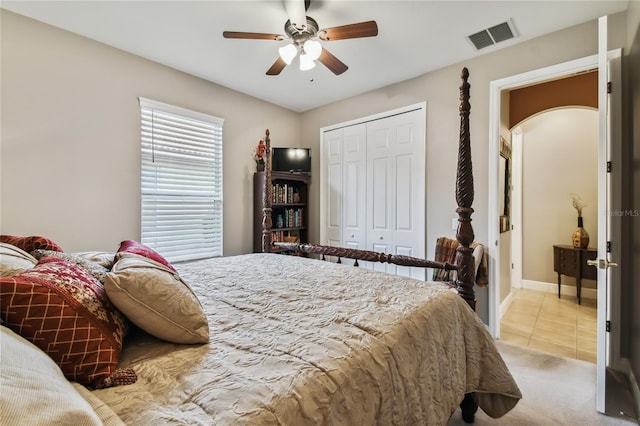 carpeted bedroom featuring ceiling fan and a closet