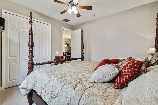 bedroom with multiple closets, light carpet, and ceiling fan