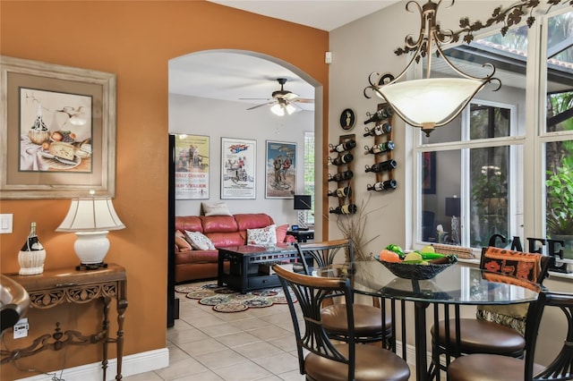 tiled dining space featuring ceiling fan