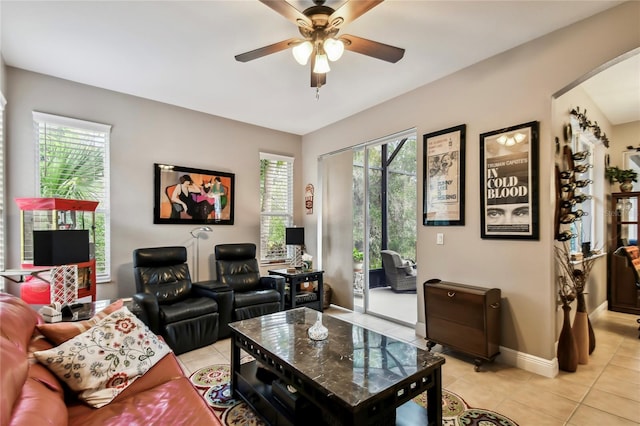 tiled living room with ceiling fan