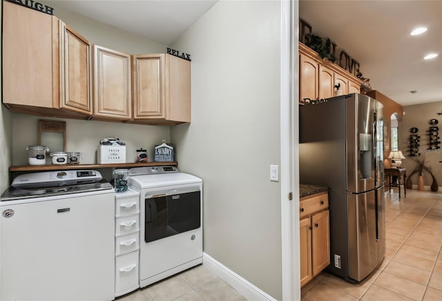 washroom with light tile patterned floors and washing machine and clothes dryer