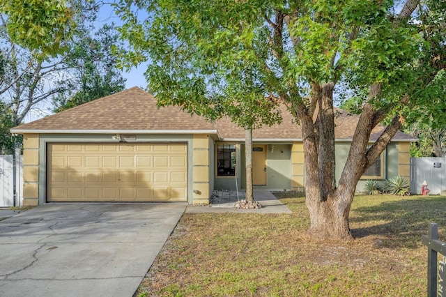 ranch-style home featuring a garage and a front lawn