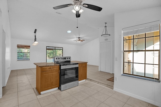 kitchen featuring stainless steel range with electric stovetop, lofted ceiling, hanging light fixtures, light tile patterned floors, and light stone counters