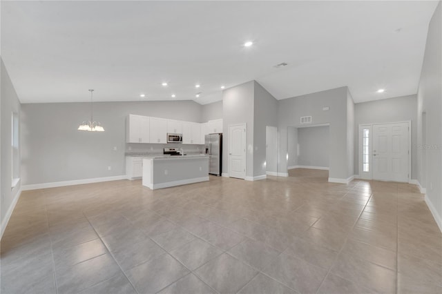 unfurnished living room with a notable chandelier, light tile patterned flooring, and high vaulted ceiling