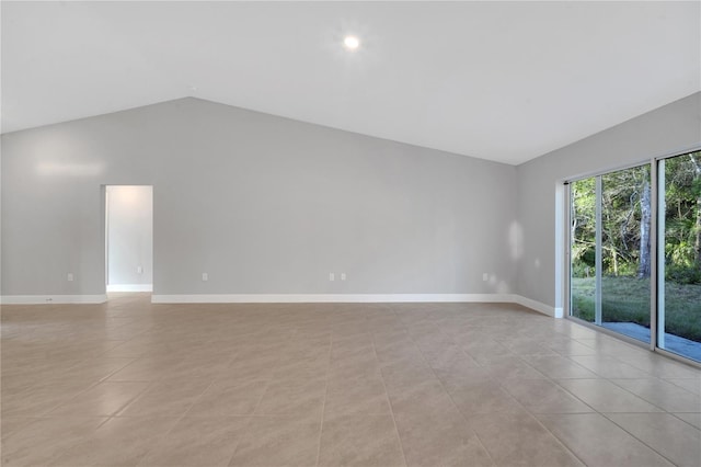 tiled empty room with vaulted ceiling