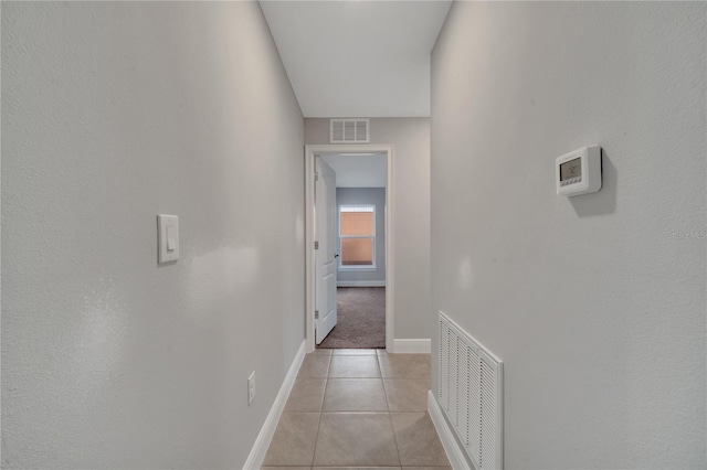 hallway featuring light tile patterned floors