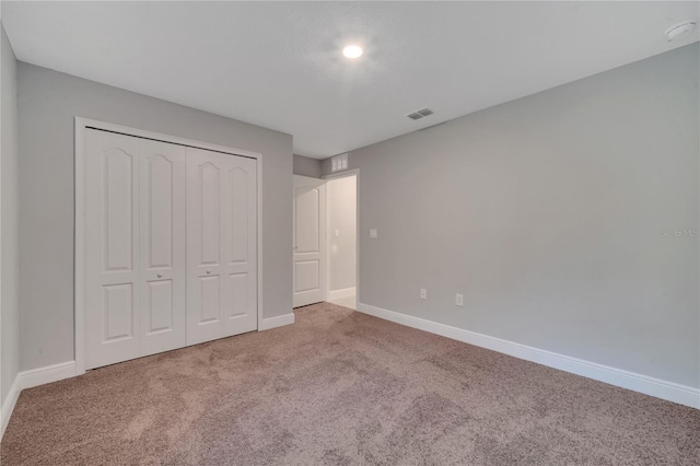 unfurnished bedroom featuring a closet and carpet