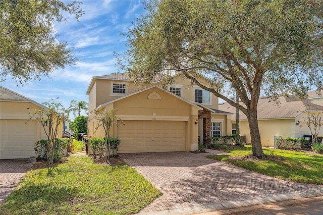 view of front property featuring a front lawn and a garage