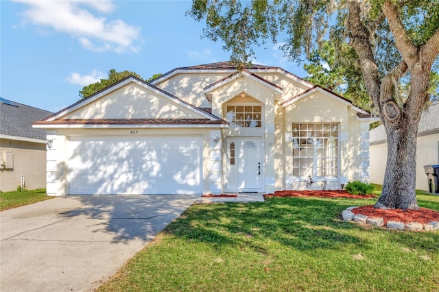 view of front of home with a front yard and a garage