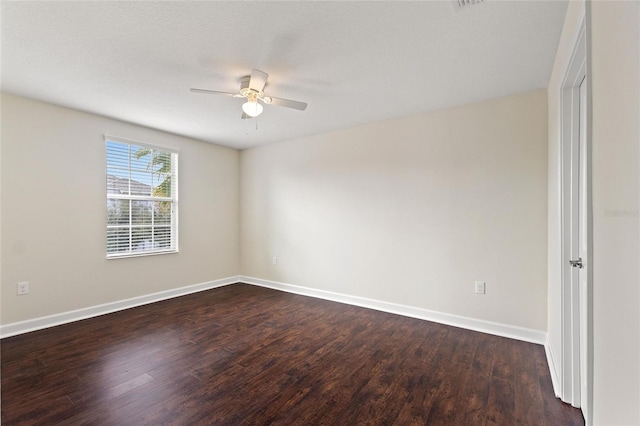 empty room featuring a textured ceiling, dark hardwood / wood-style floors, and ceiling fan