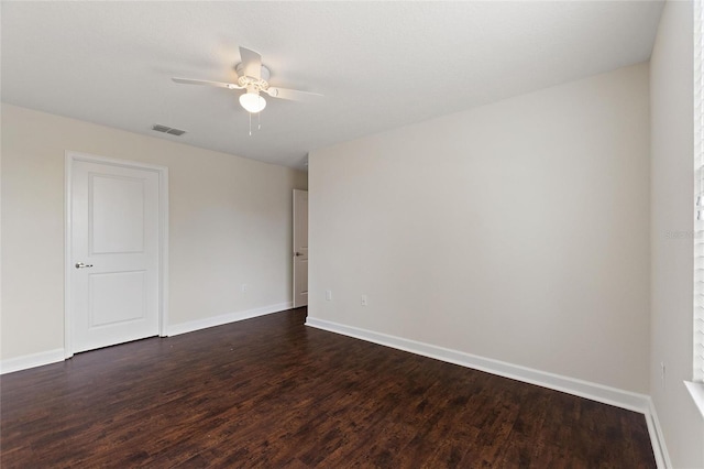 empty room with ceiling fan and dark hardwood / wood-style floors