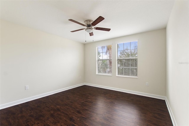 spare room with dark hardwood / wood-style flooring and ceiling fan