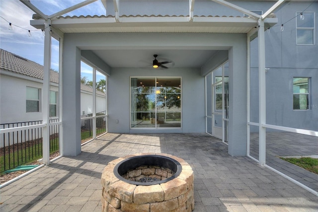 view of patio with an outdoor fire pit and ceiling fan