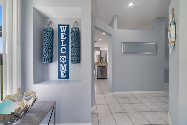 hall featuring light tile patterned floors