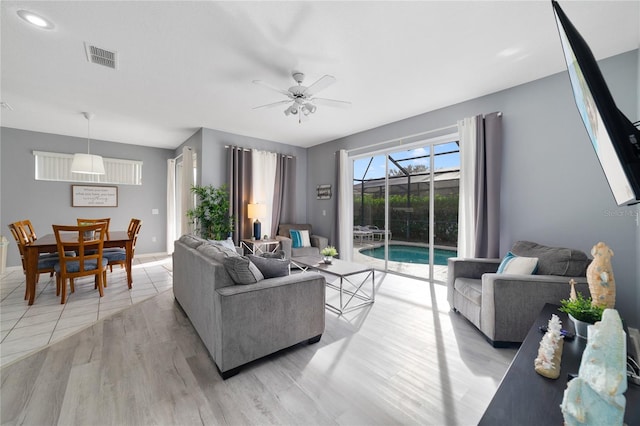 living room featuring light hardwood / wood-style floors and ceiling fan