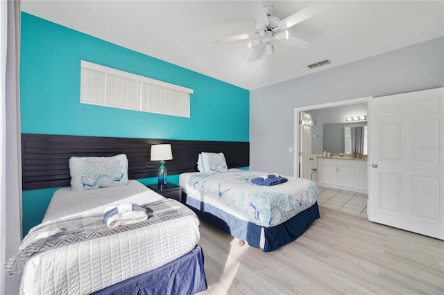 bedroom featuring connected bathroom, light wood-type flooring, and ceiling fan