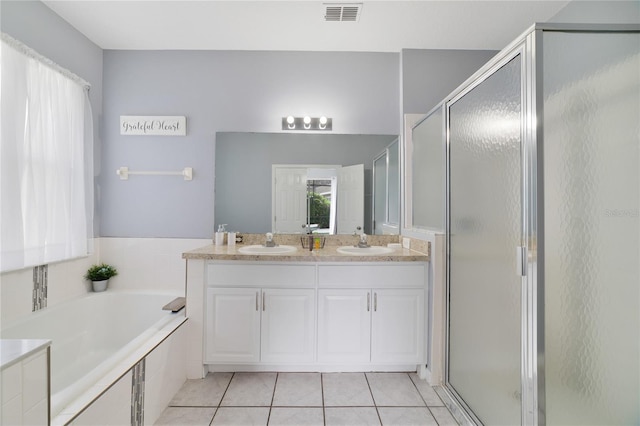 bathroom with independent shower and bath, vanity, and tile patterned floors