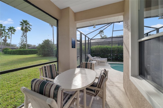 sunroom featuring a pool