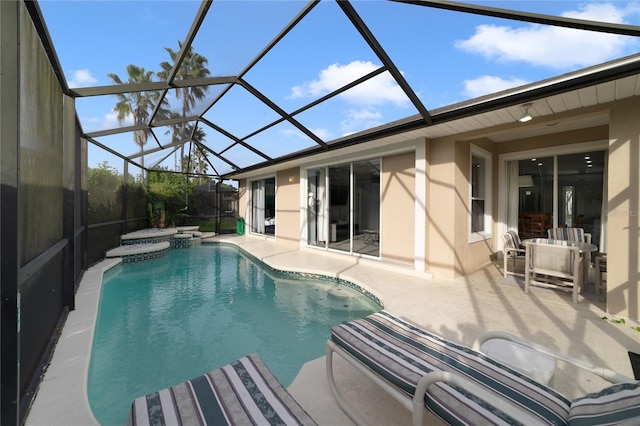 view of pool featuring a lanai, an in ground hot tub, and a patio area