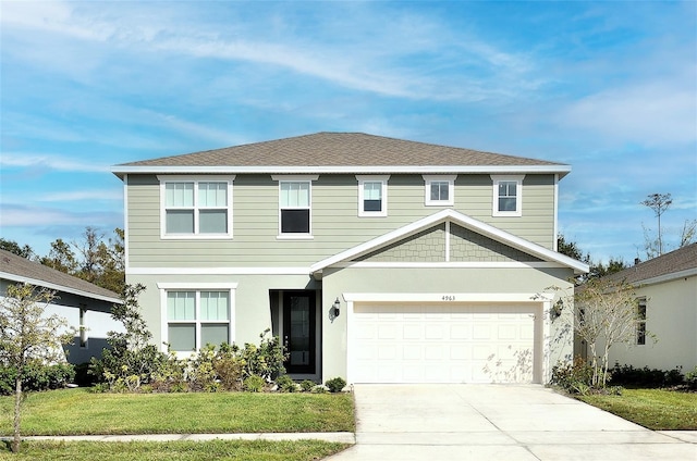 view of front facade with a front lawn and a garage